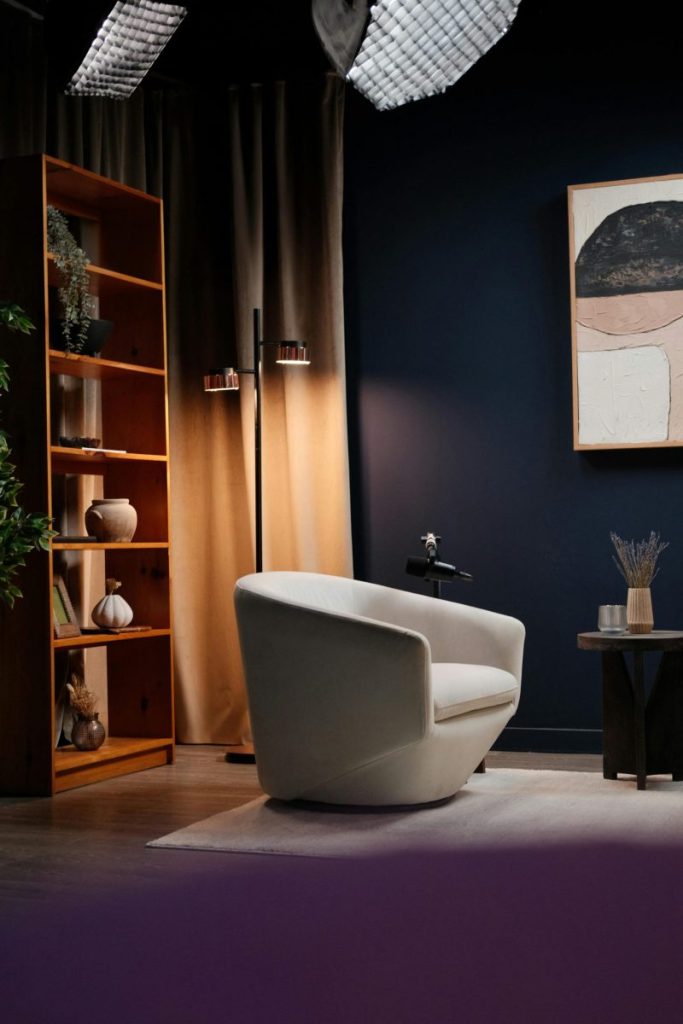 Stylish podcast studio in Montreal with cozy seating, bookshelf, and modern art.